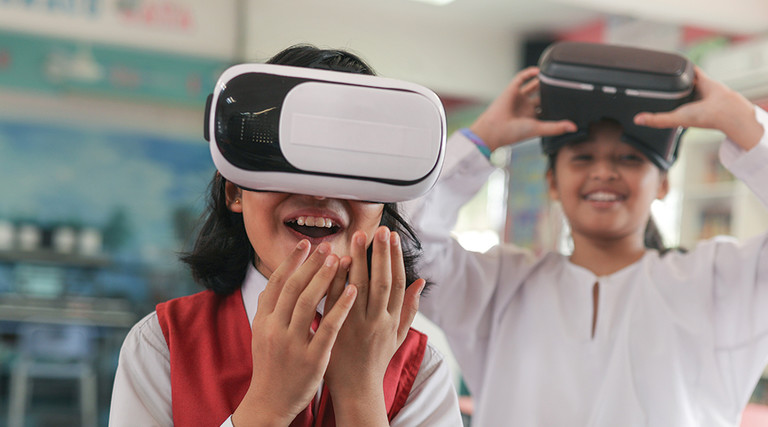 two kids using a vr headset