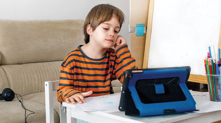 Boy using tablet for remote learning