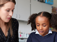 Teacher working closely with student
