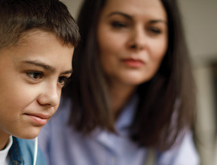 Boy doing online learning with parent