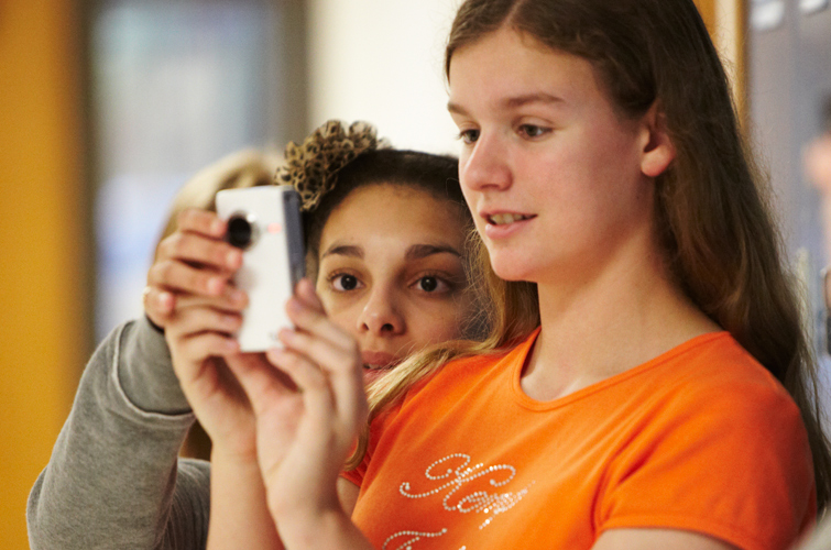 Future Is Now program participants Erika Felix (left) and Abigail Bell take a look at the footage Bell recorded using one of Kemp Junior High School’s Flip video cameras.