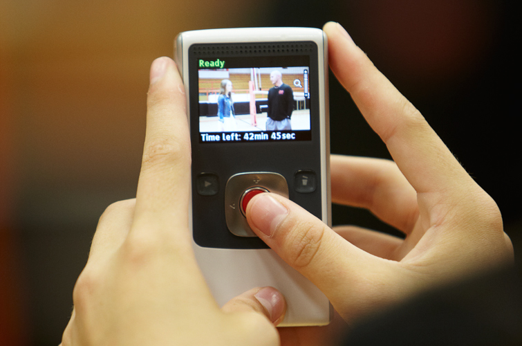 A FIN student records a conversation between another student and a teacher using one of the school’s Flip video cameras.