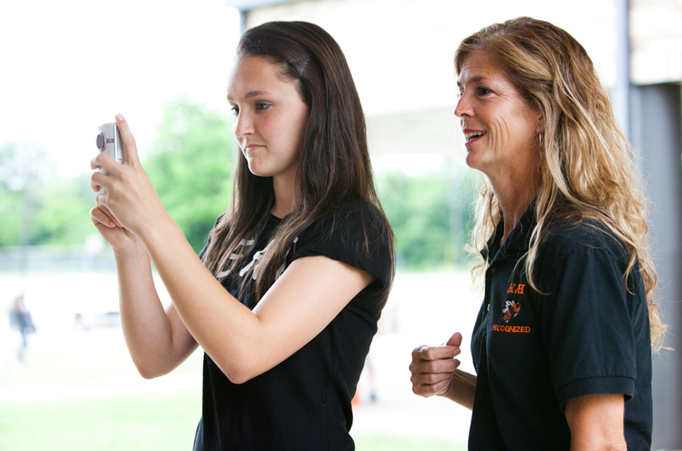 Hannah Hosch films a segment for the FIN program’s biweekly video broadcast as Kelly Delaney, Kemp Junior High School’s technology teacher and FIN program co-coordinator, looks on.