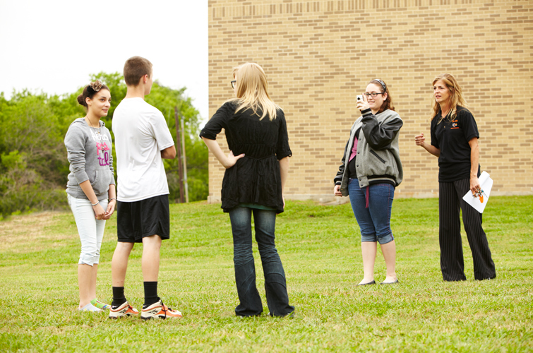 Kimberly Gardiner (second from right) records fellow students Erika Felix (from left), D.J. Scott and Courtney Putnam. FIN program co-coordinator Kelly Delaney (far right) says FIN members interview different students and teachers throughout the year to showcase in the program’s biweekly video broadcast.