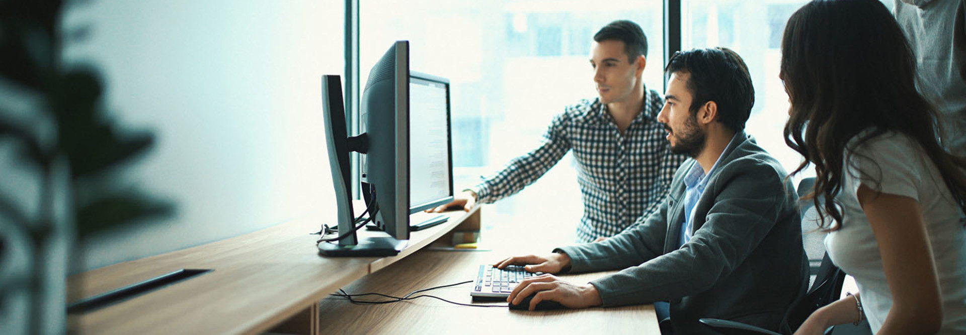 Young professionals looking at a computer