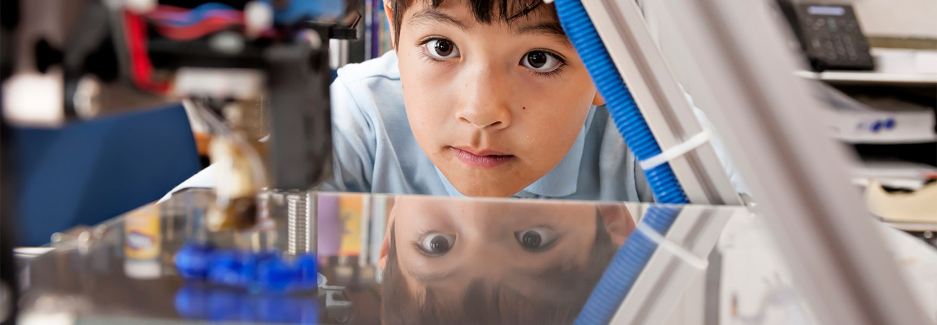Boy watches 3d printer