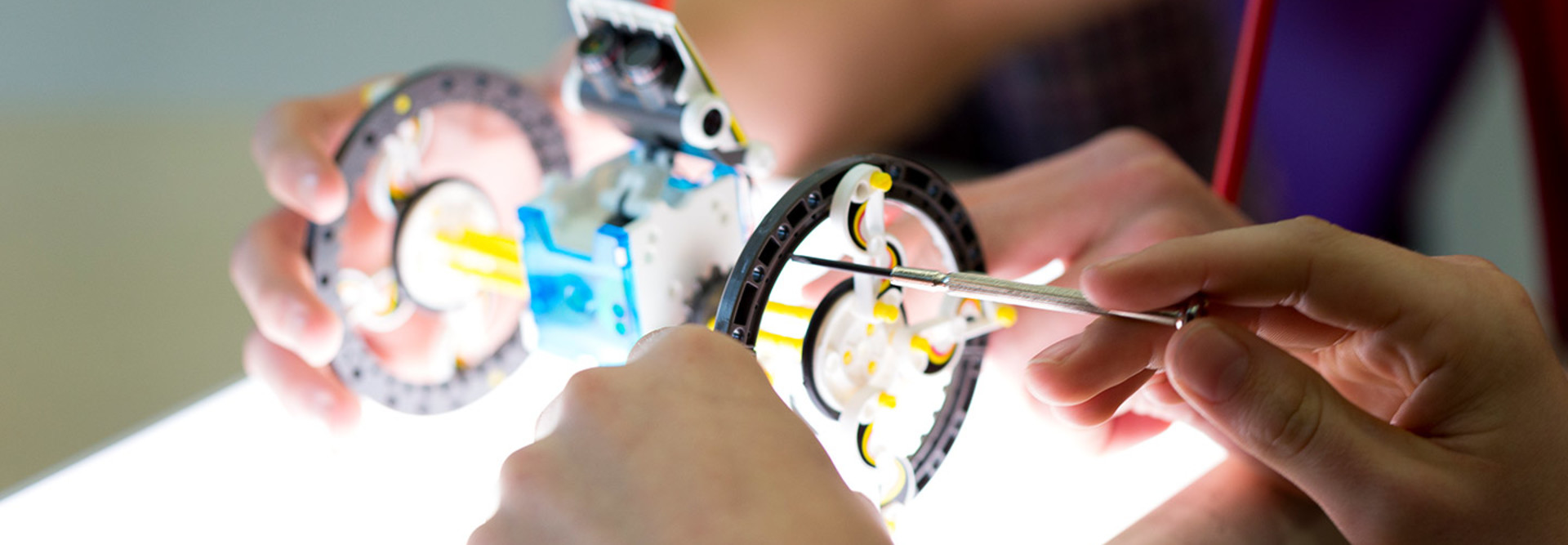 Person tinkering with robot