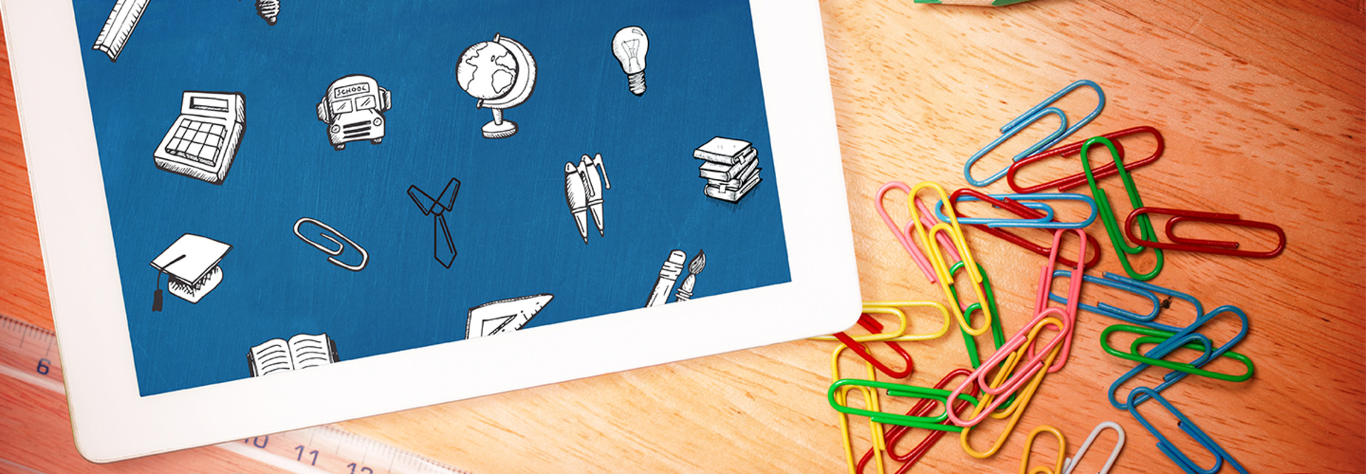 Tablet and paperclips on desk