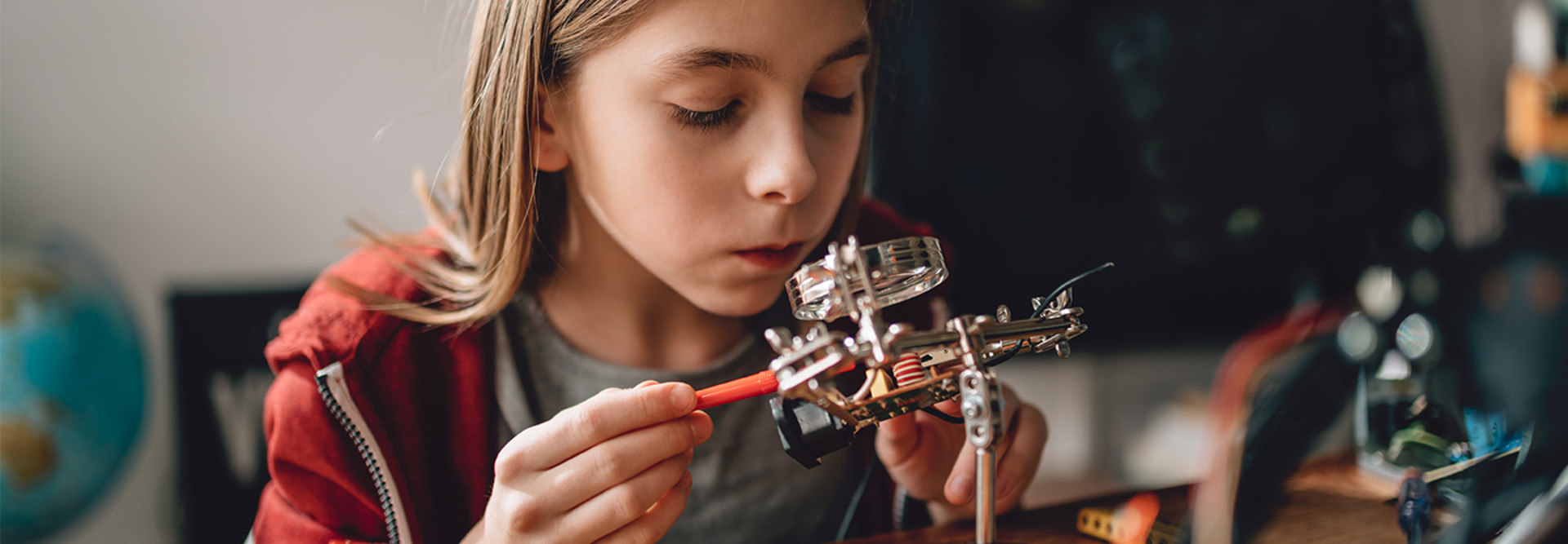 girl tinkering with robot