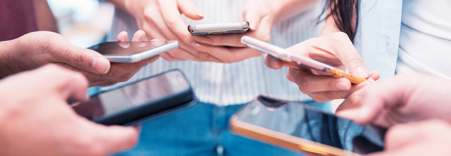 Group of people holding their smartphone and testing a mobile app.