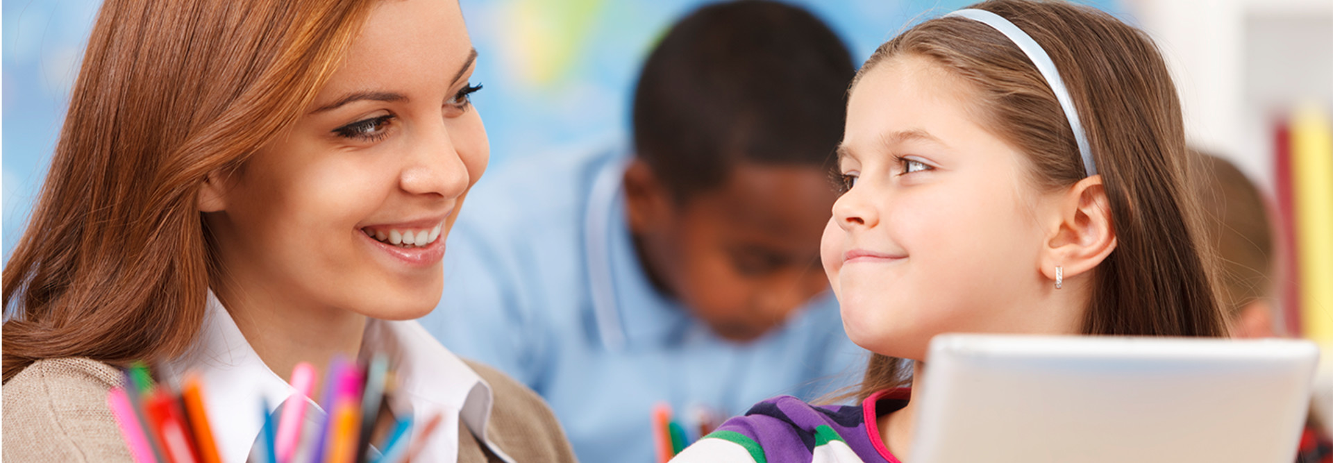 teacher and girl with tablet