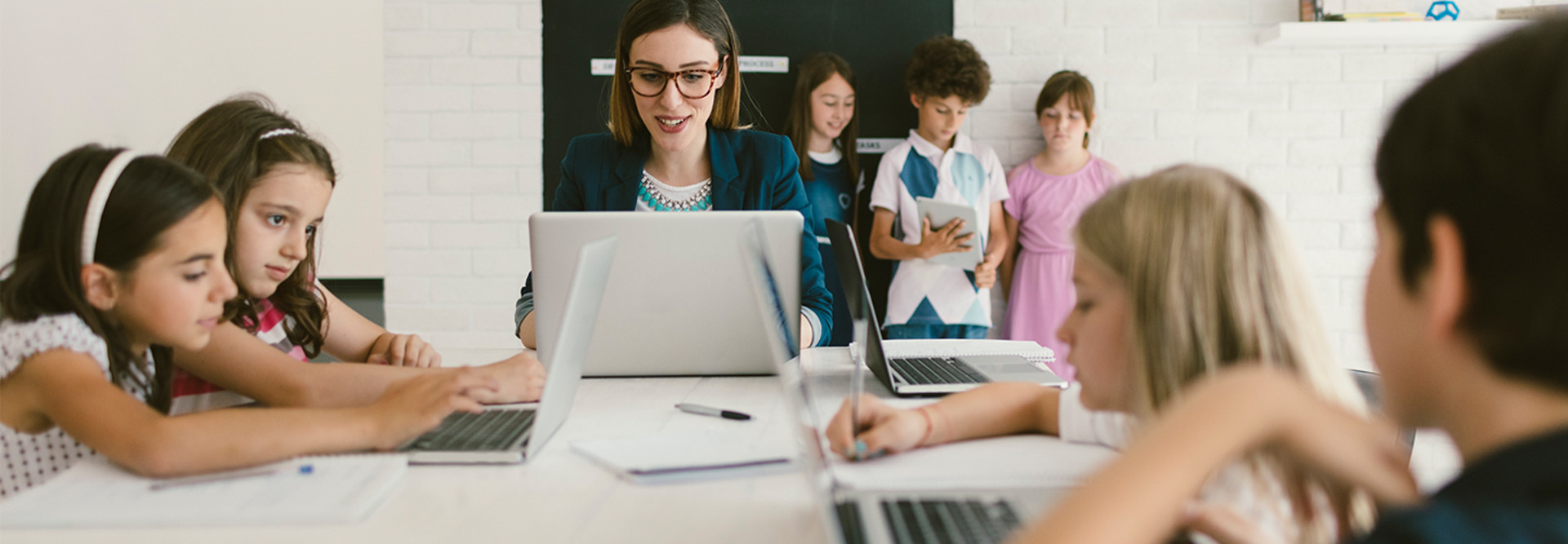 Students and teacher on computers