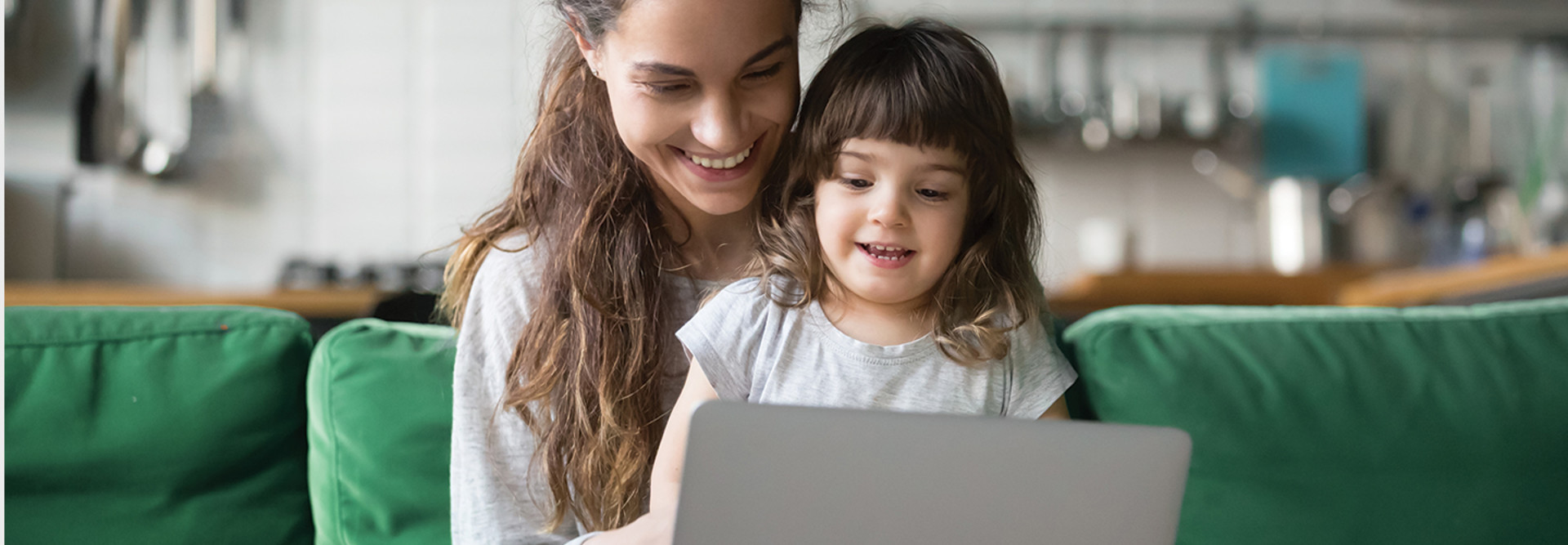 parent and child looking at laptop
