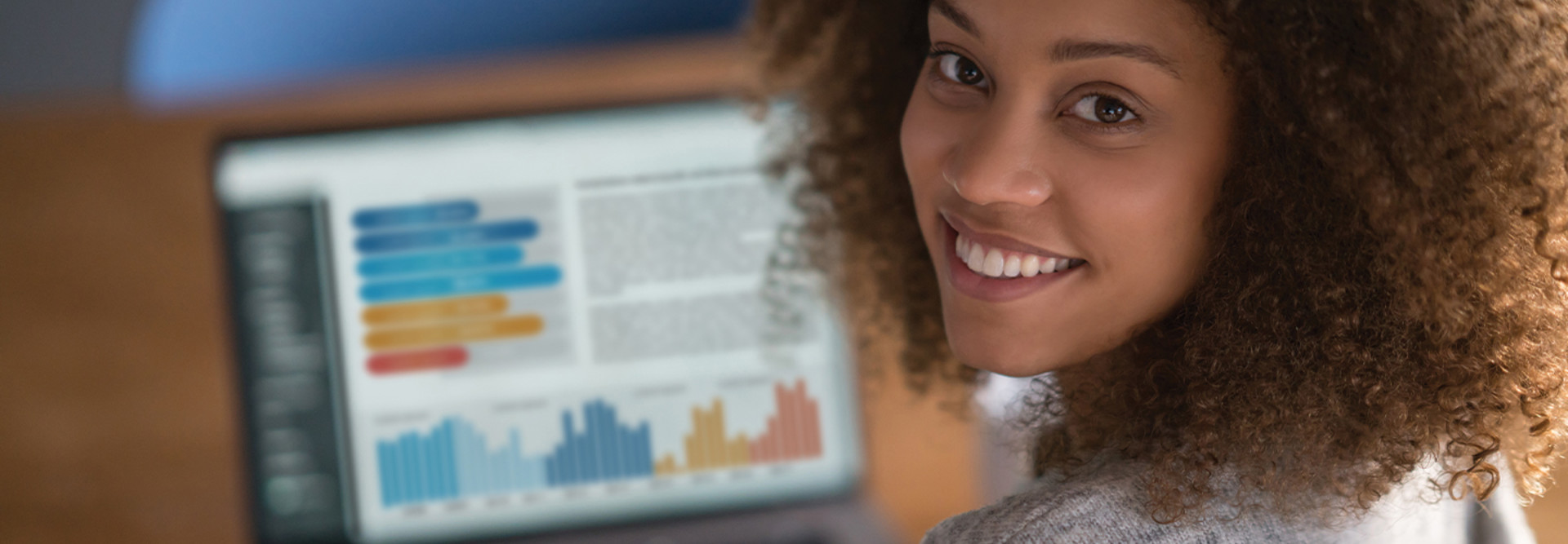 woman looking at data on a laptop
