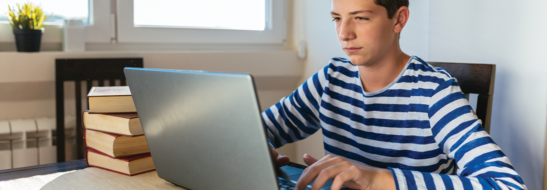 boy using laptop at home