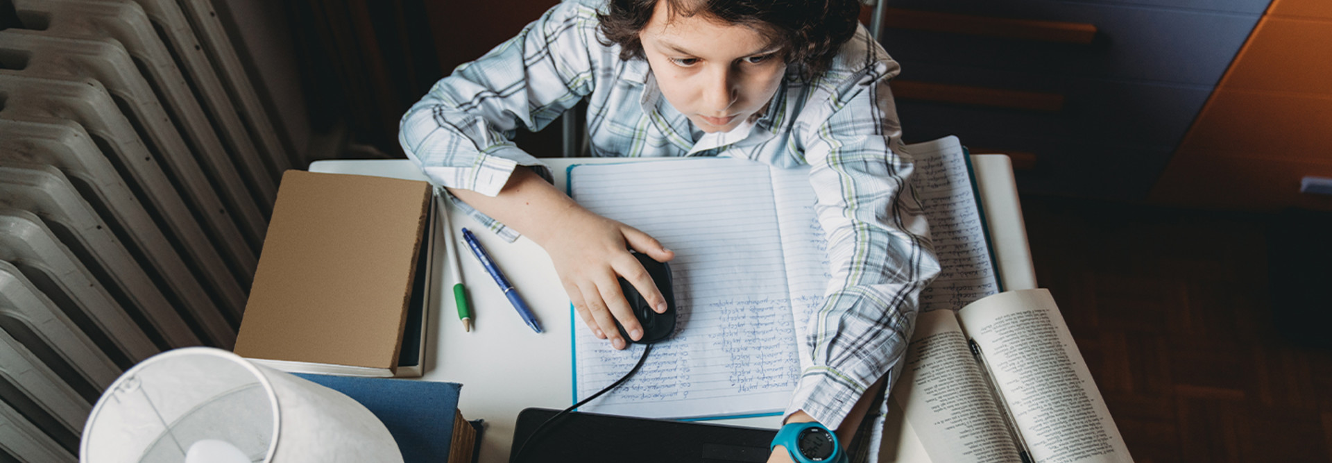 boy using laptop at home for school work