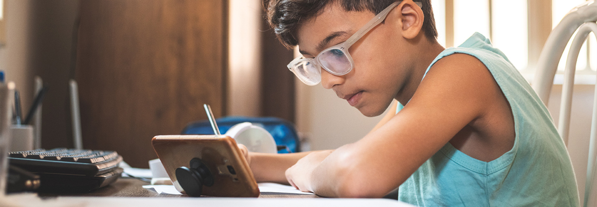 boy using mobile phone for online learning