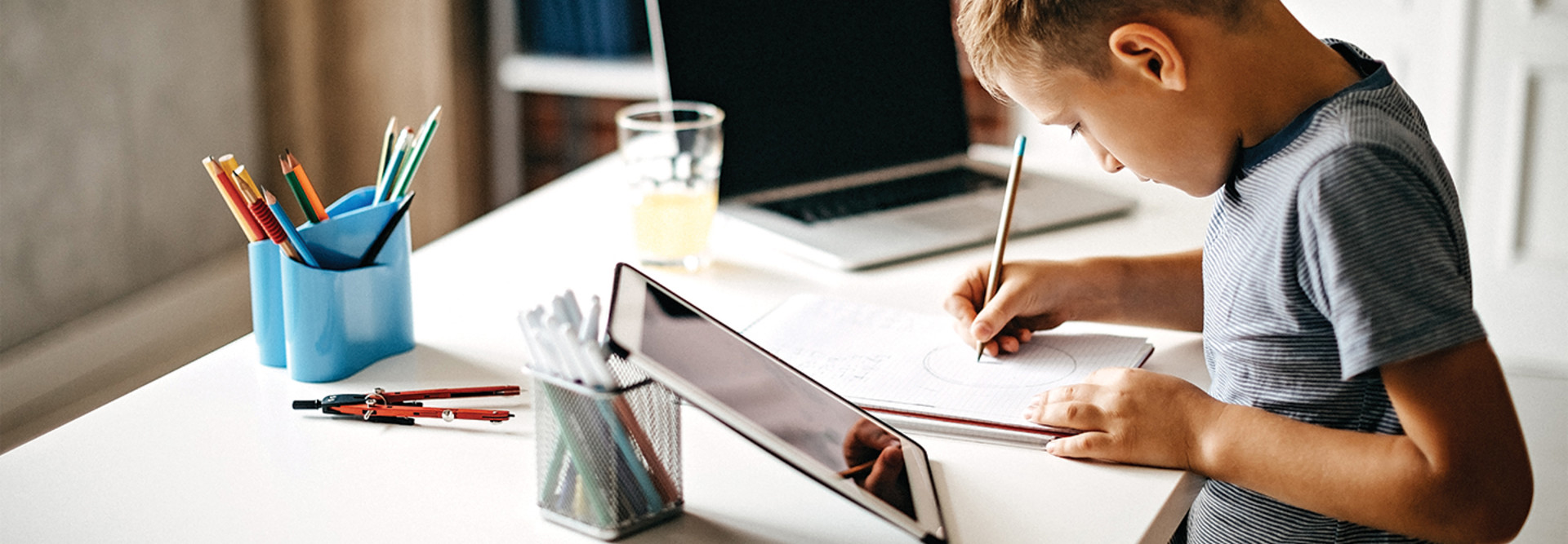 boy using laptop at home for learning