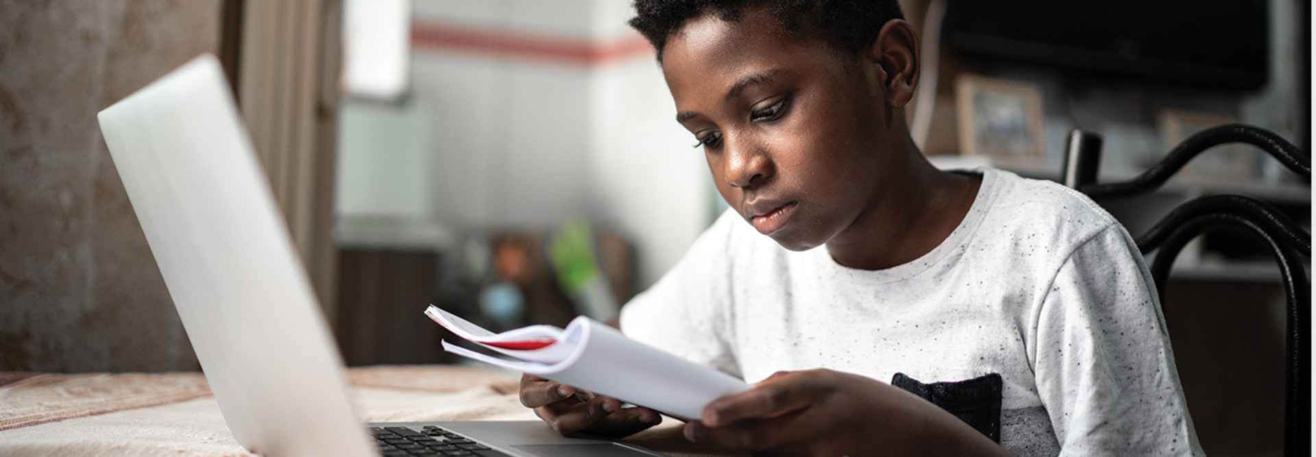 child with laptop on an online class at home
