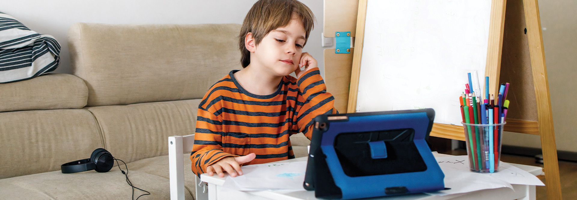 Boy using tablet for remote learning