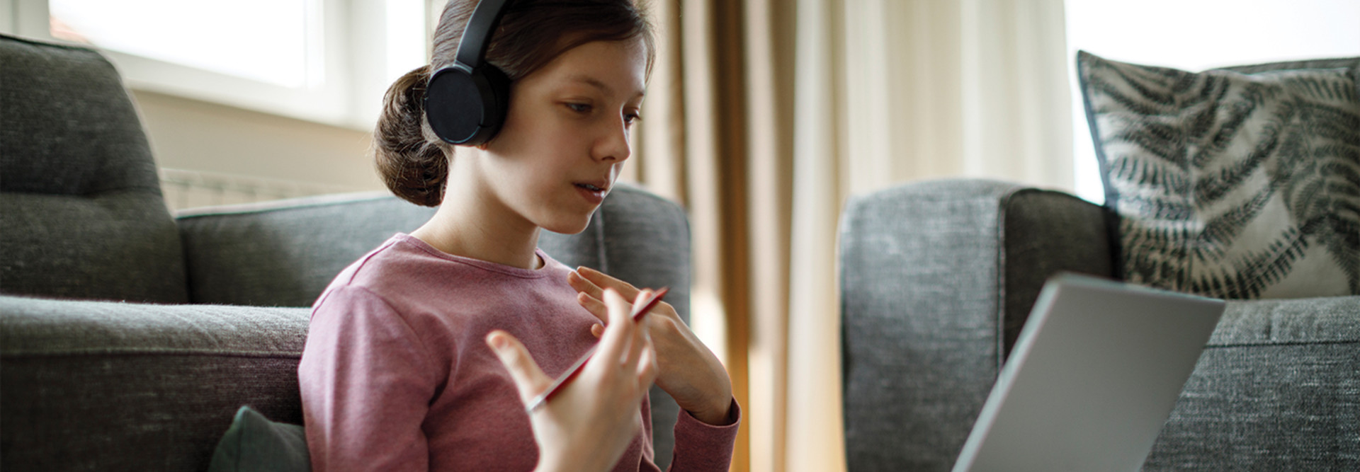 girl with headphones using laptop