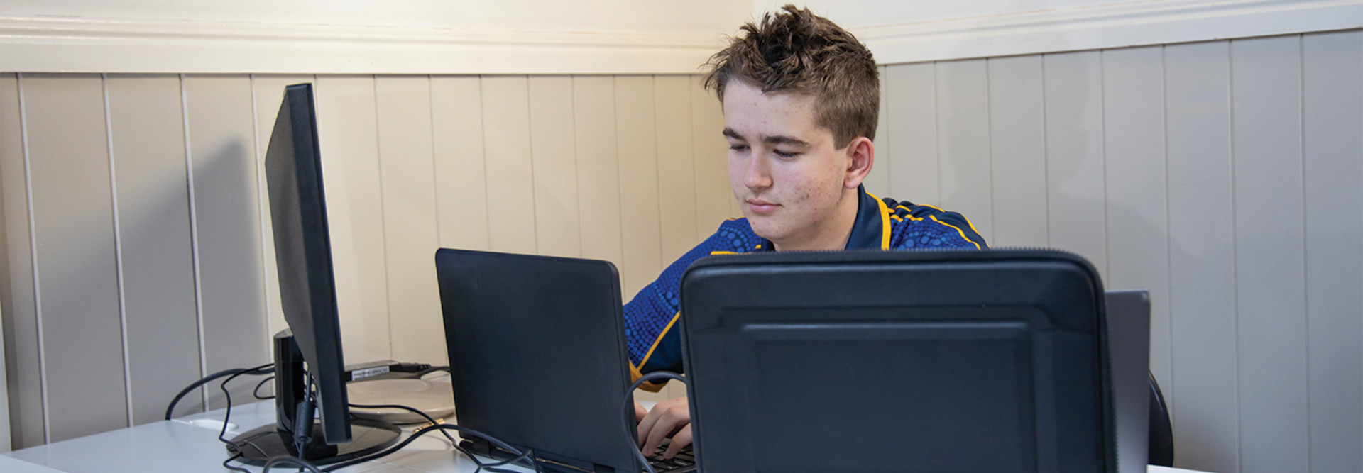 teenage boy using computer at home