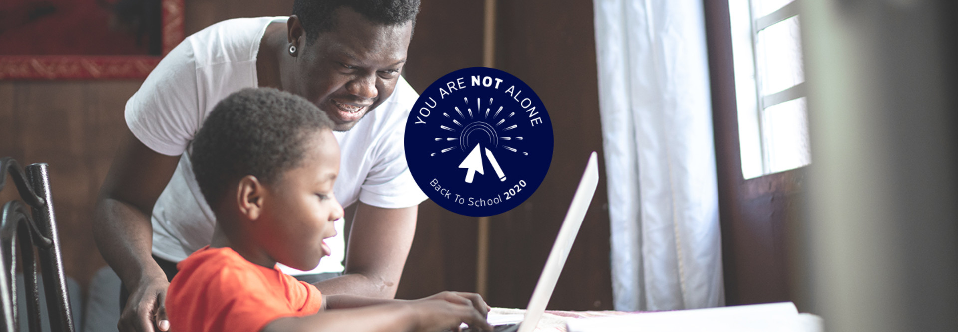 father helping son with online homework