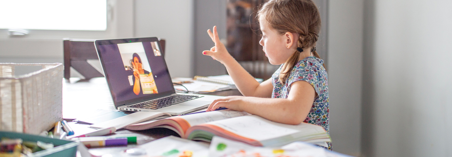 little girl learns from home while teacher teaches remotely