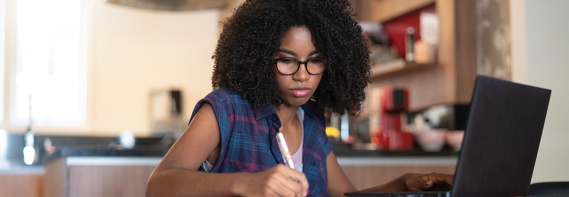 teenager girl studying in the kitchen