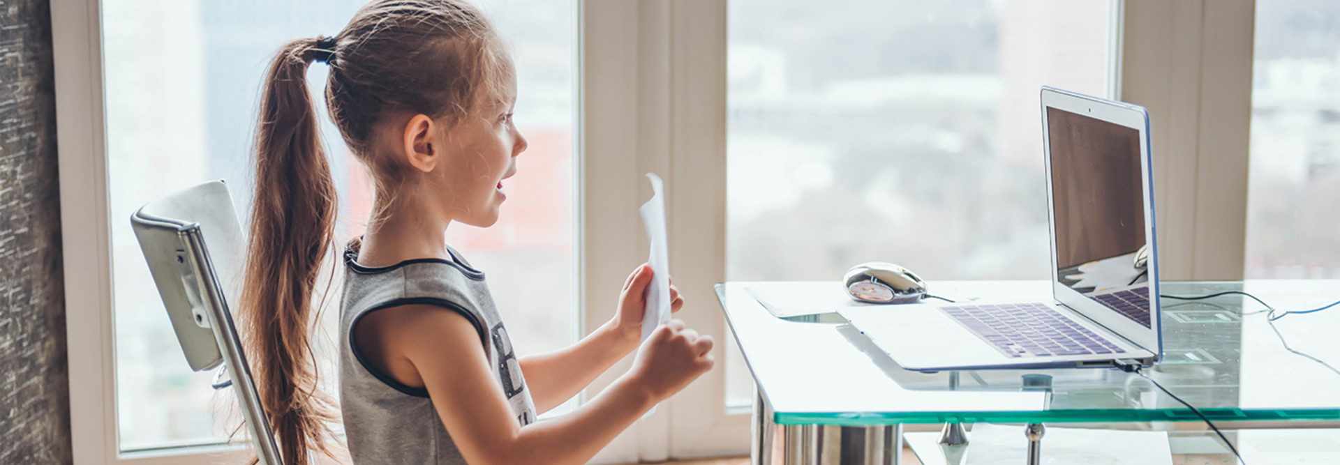 girl showing classwork on video chat