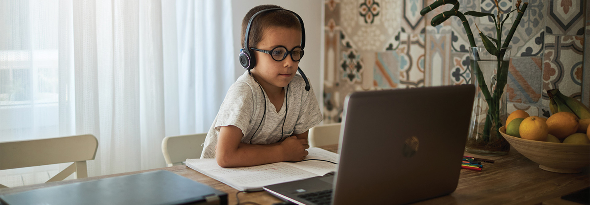 boy using laptop at home for learning