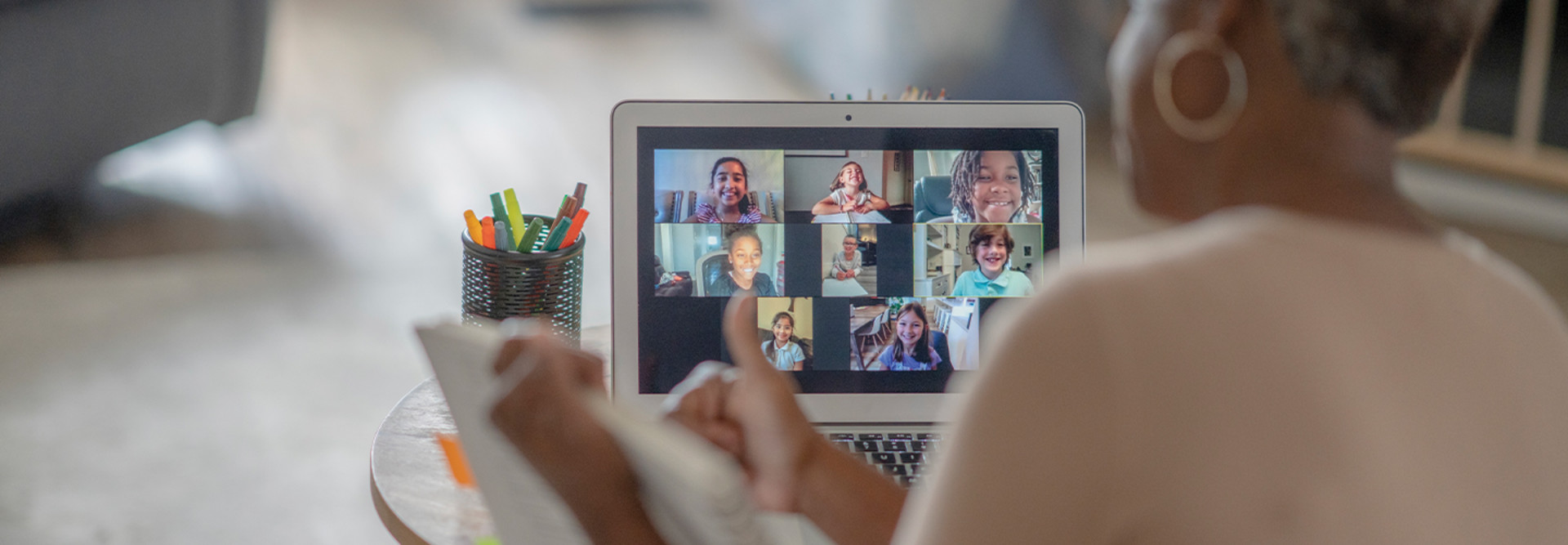 teacher teaching remotely with laptop