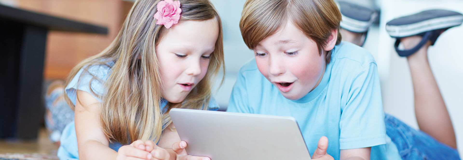 Two kids using a tablet for digital learning 