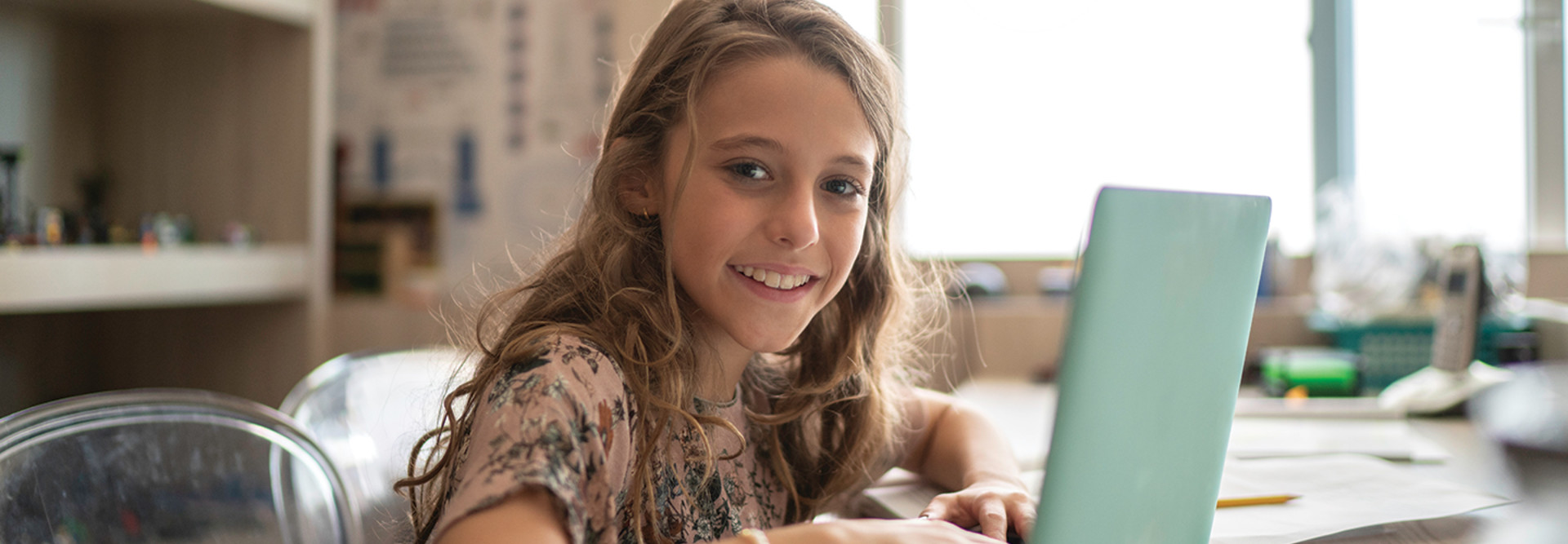 girl remote learning on laptop at home