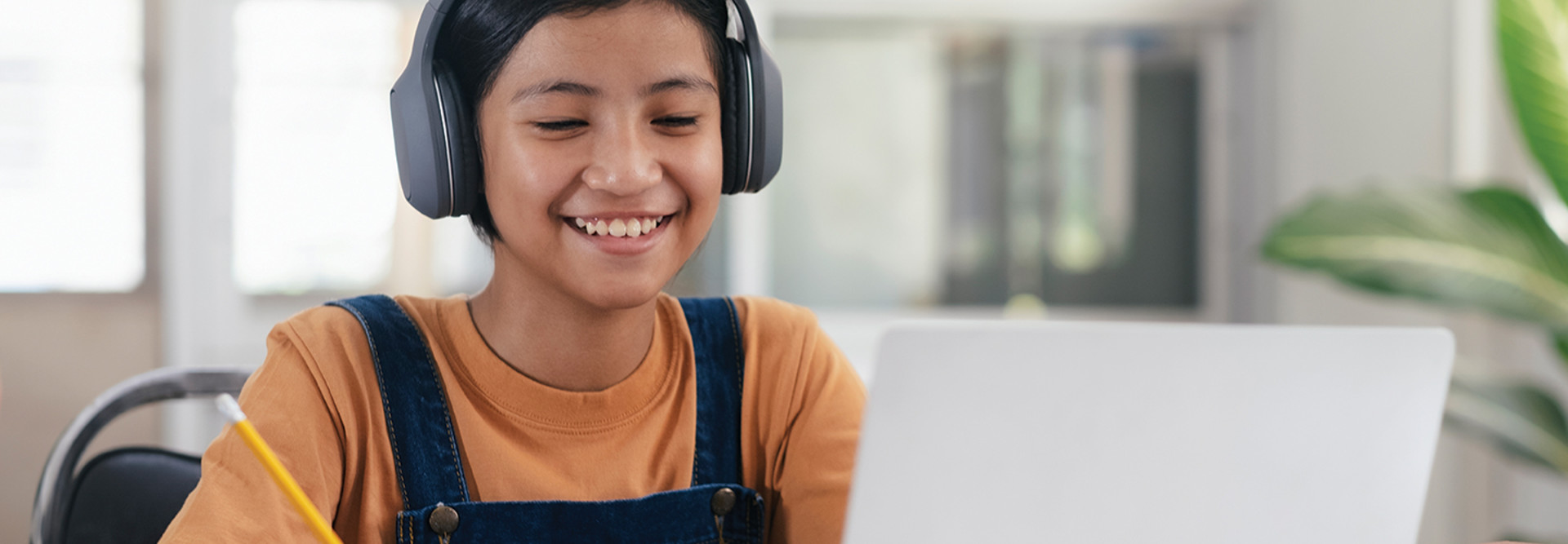 Student on laptop with headphones 