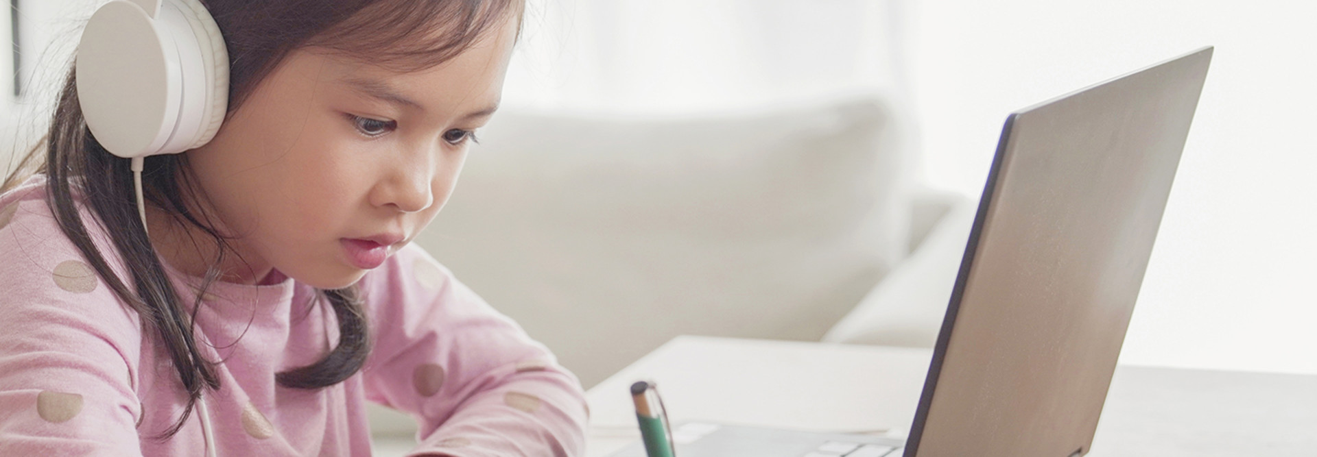 Girl with headphones on laptop 