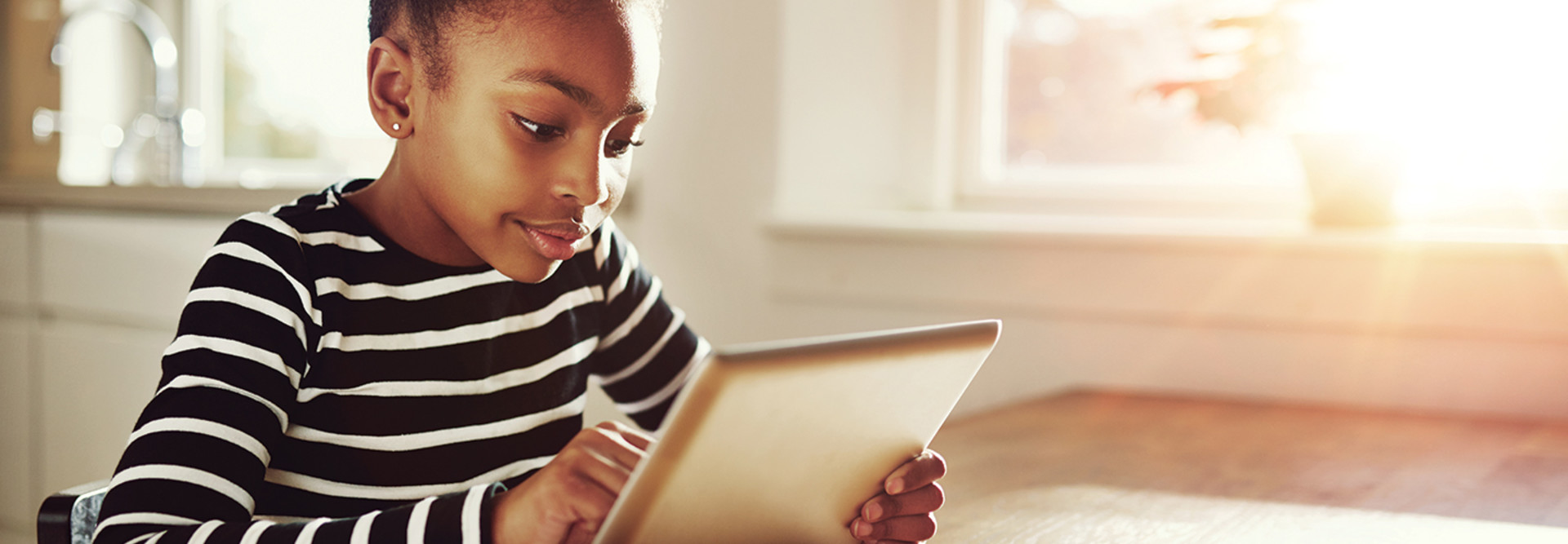Young girl looking at tablet