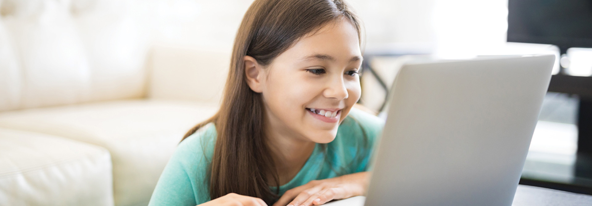 young girl on laptop smiling 