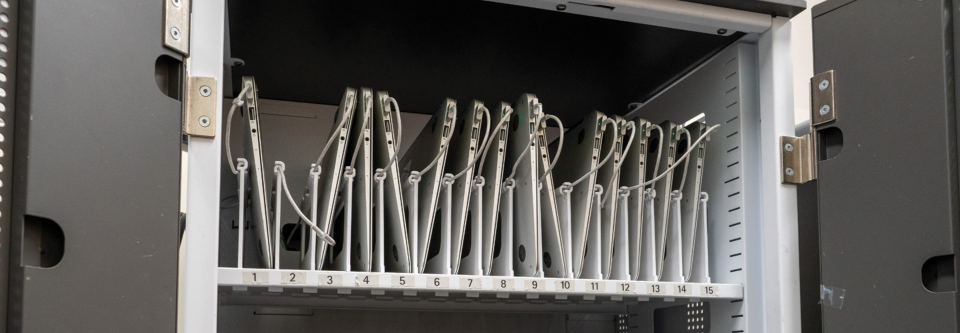 Laptops in a device charging technology cart in the K–12 classroom