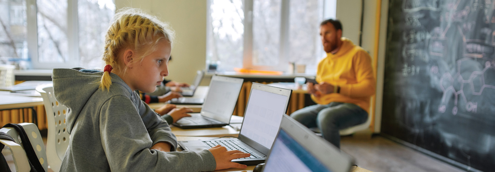 Students on laptops in classroom