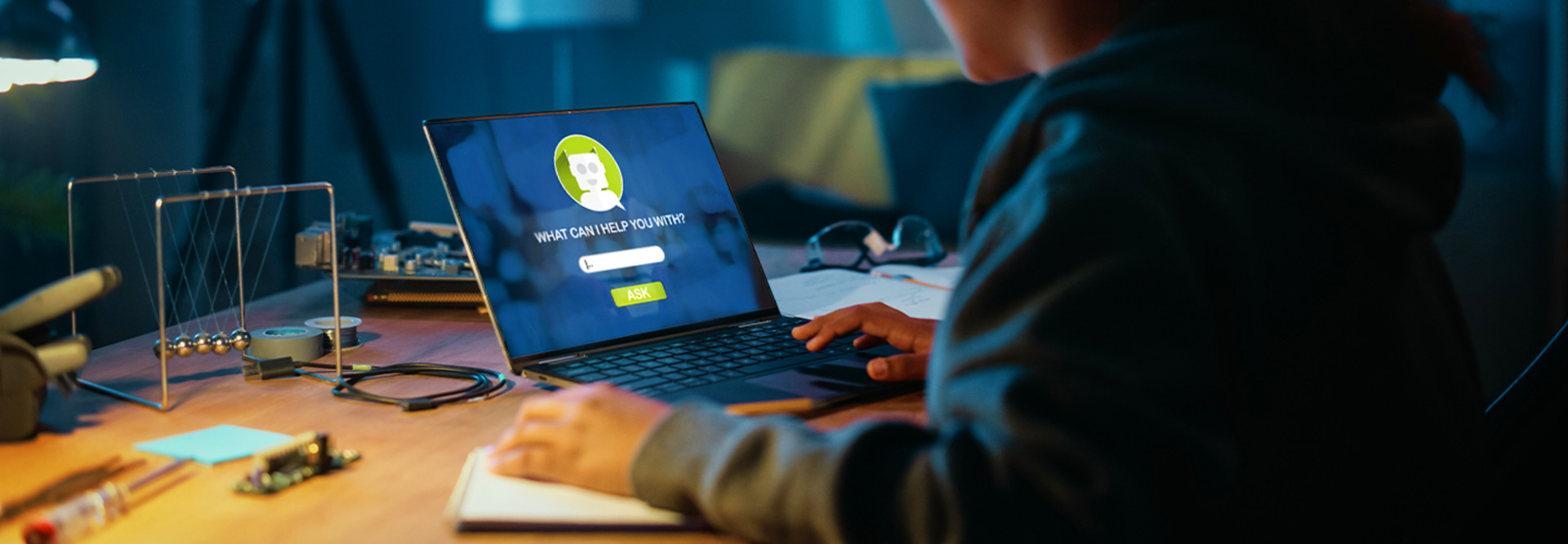 Student sitting at laptop with AI chatbot on the screen
