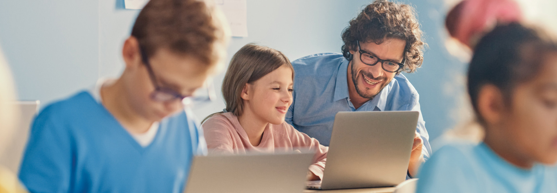 Students working on laptops with real AI networking