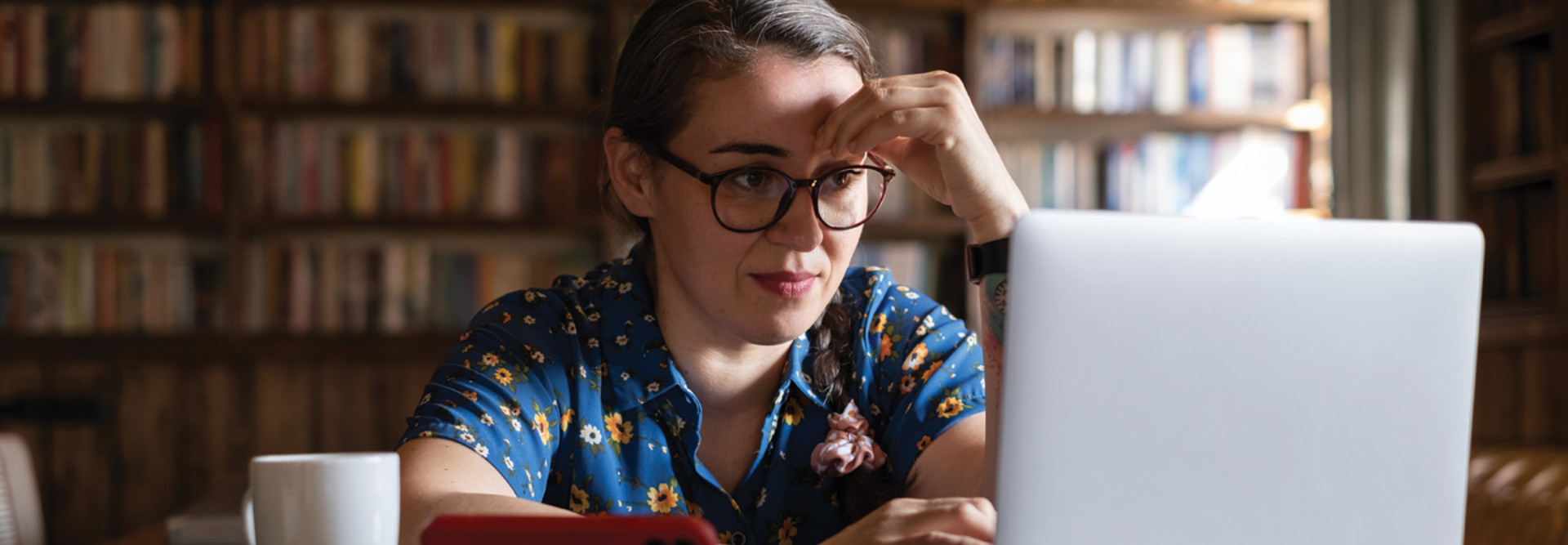 Woman in library looking at computer - password protection