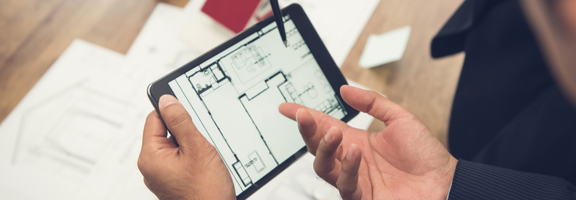 Leaders plan using a blueprint on a tablet