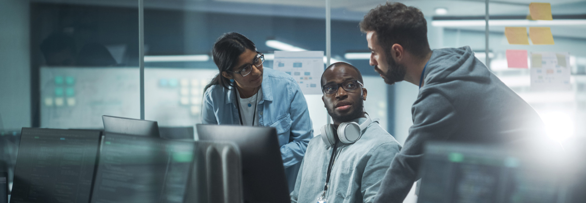 IT leaders discussing cybersecurity insurance around computers