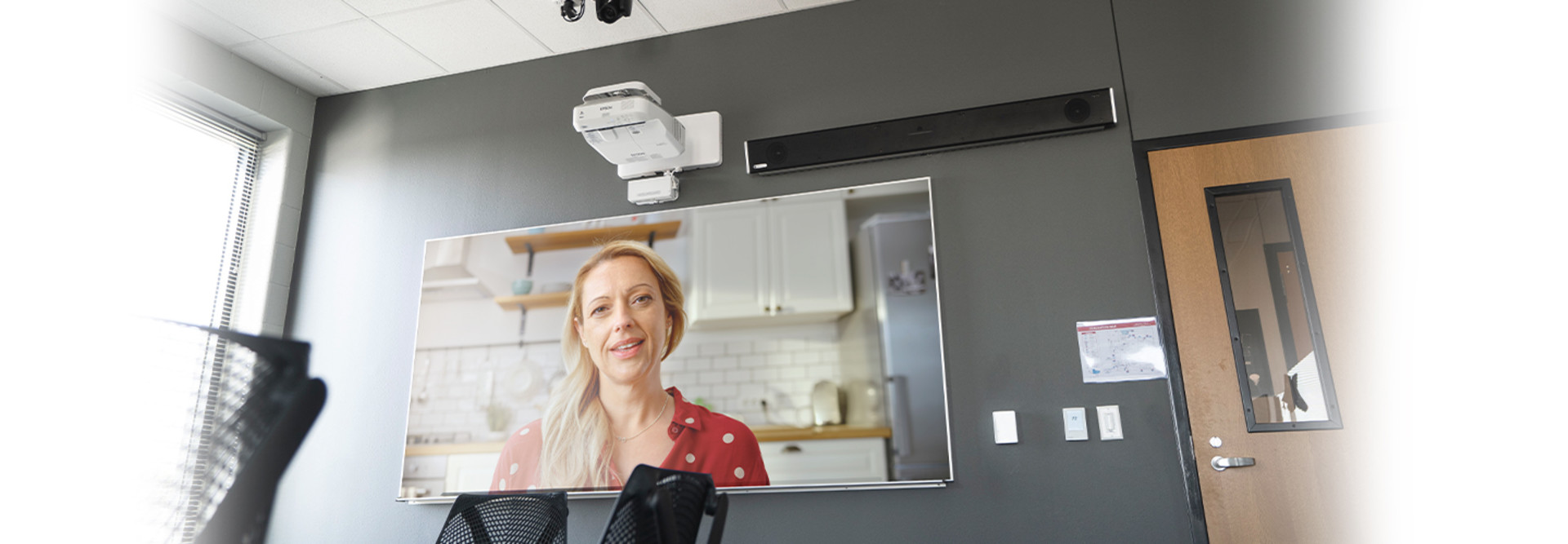 parent on screen in classroom for virtual conference