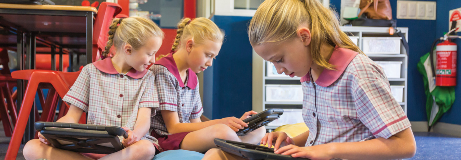 Students in a classroom using tablets