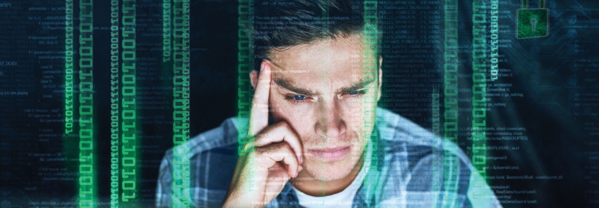 Man staring at computer with overlay of binary code