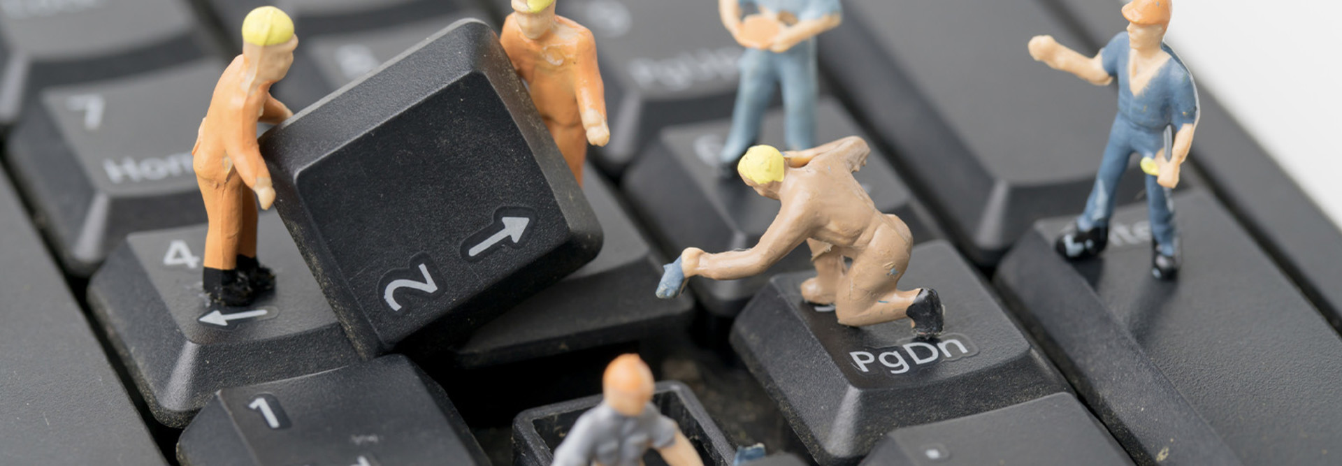 Miniature figurines work on computer keyboard