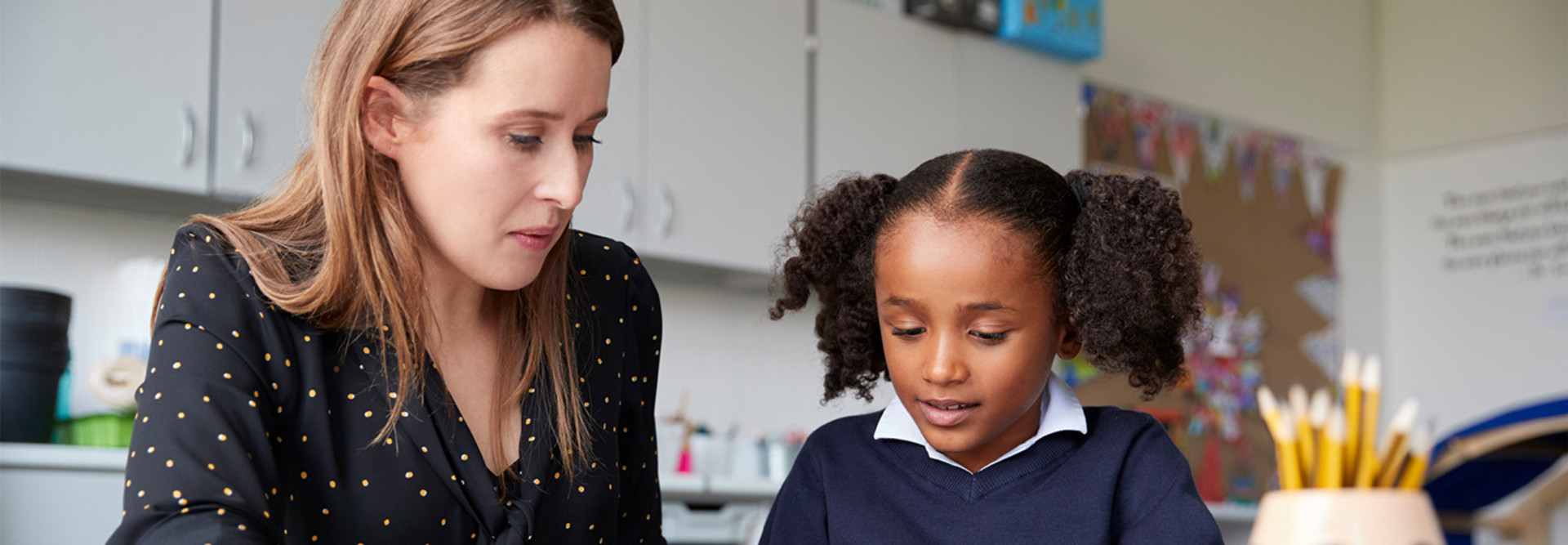Teacher working closely with student